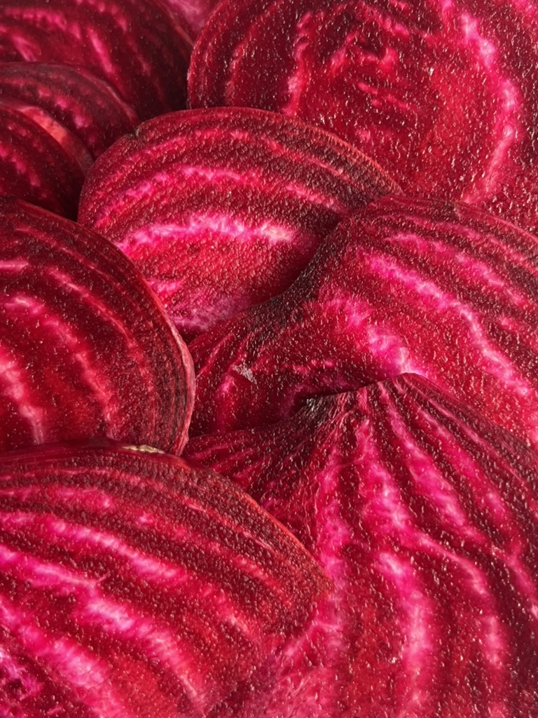 Close-up of overlapping slices of deep red beetroot